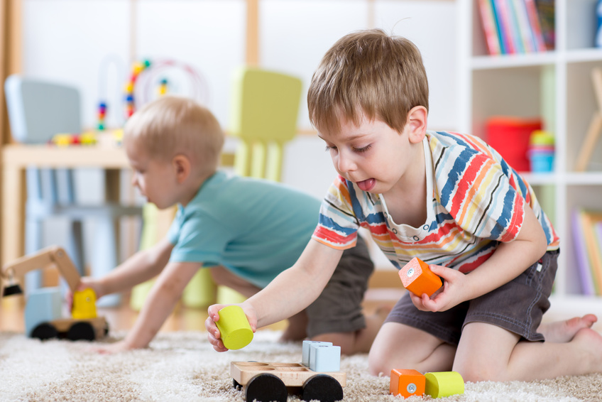 Children Playing With Toys In Kindergarten Or Daycare Or Home - Growing 